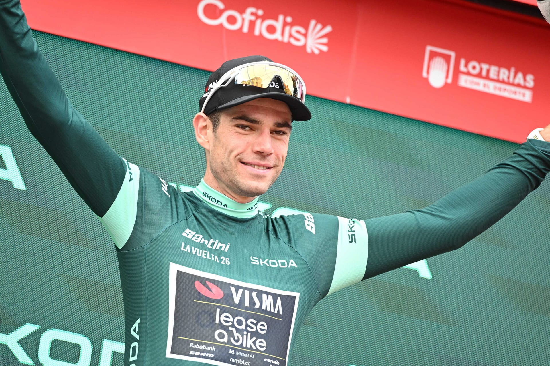 Wout van Aert raises his arms on the podium after Vuelta a España Stage 11 in Lorca