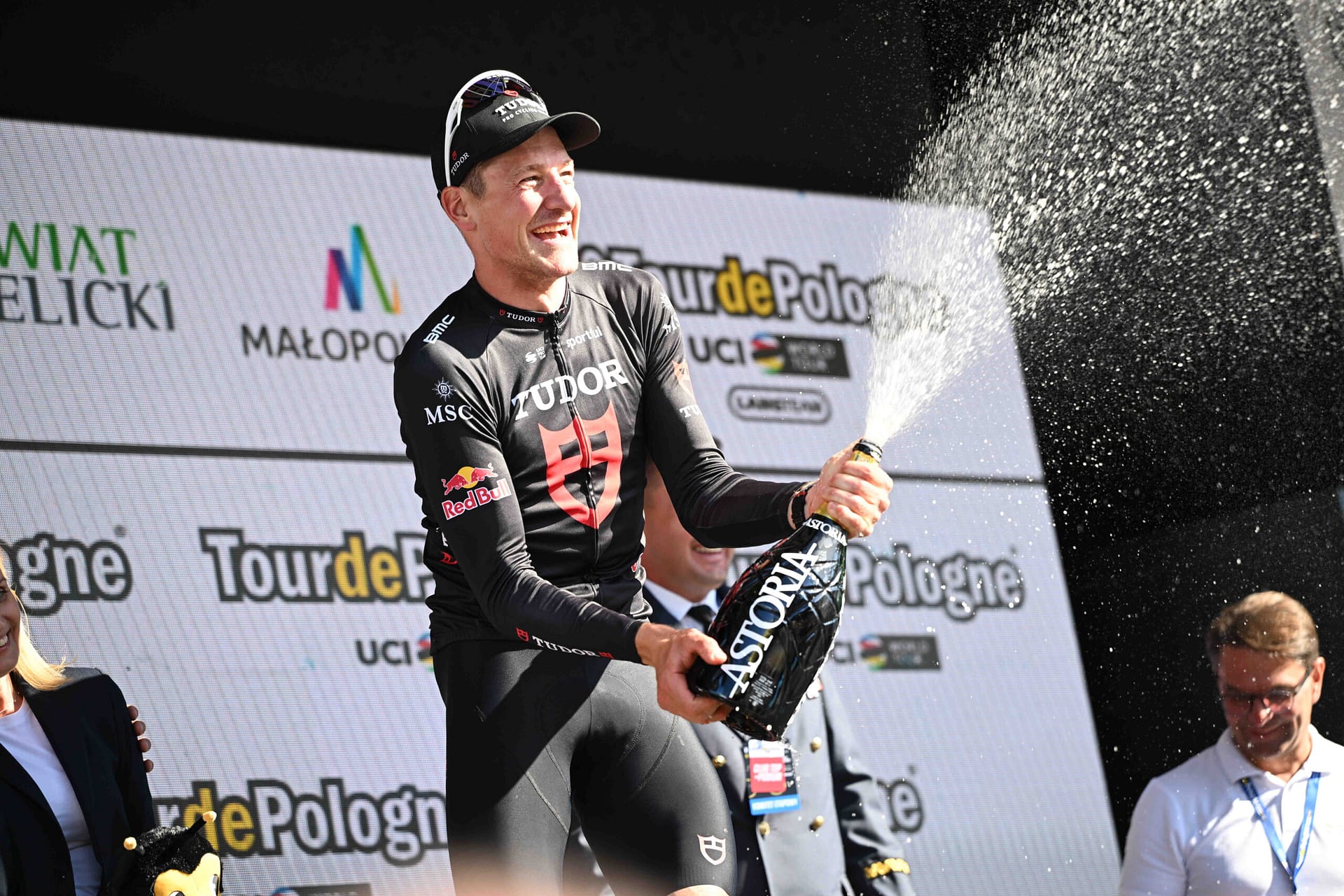 Tudor cyclist Stefan Kung celebrates on the Tour de Pologne podium at Wieliczka, spraying champagne