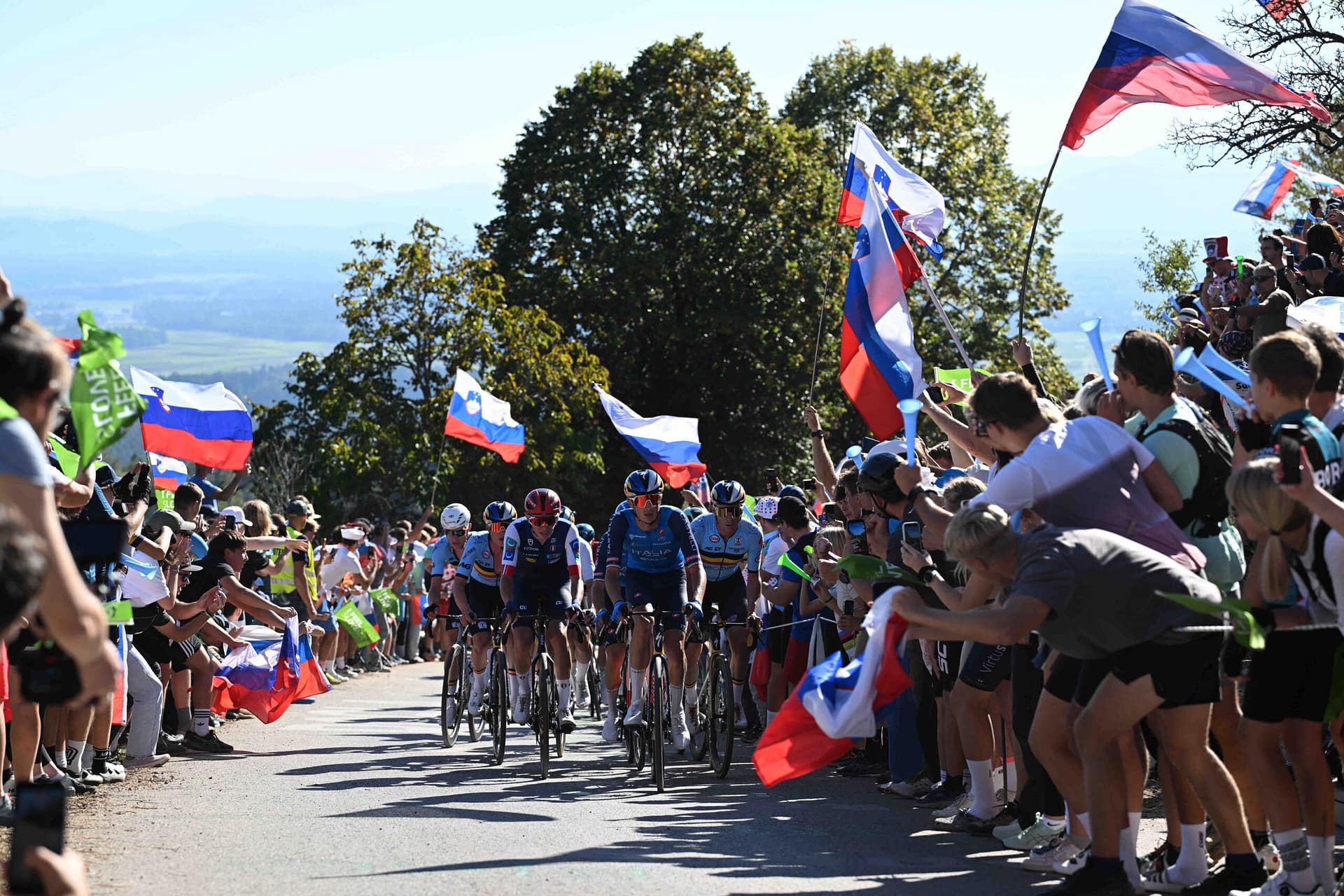 Remco Evenepoel and Red Bull-Bora-Hansgrohe riders race past cheering fans at the European Championships