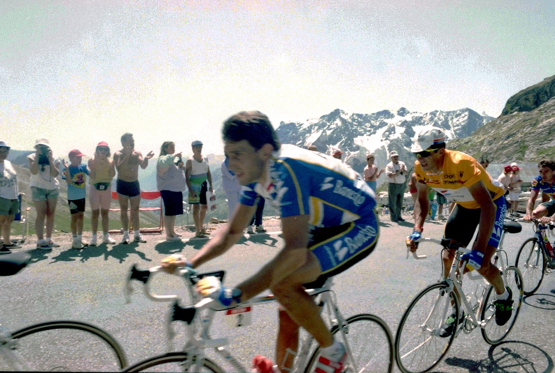 Cyclist in blue and yellow kit rides past spectators during 1992 Tour de France on Alpe d’Huez road
