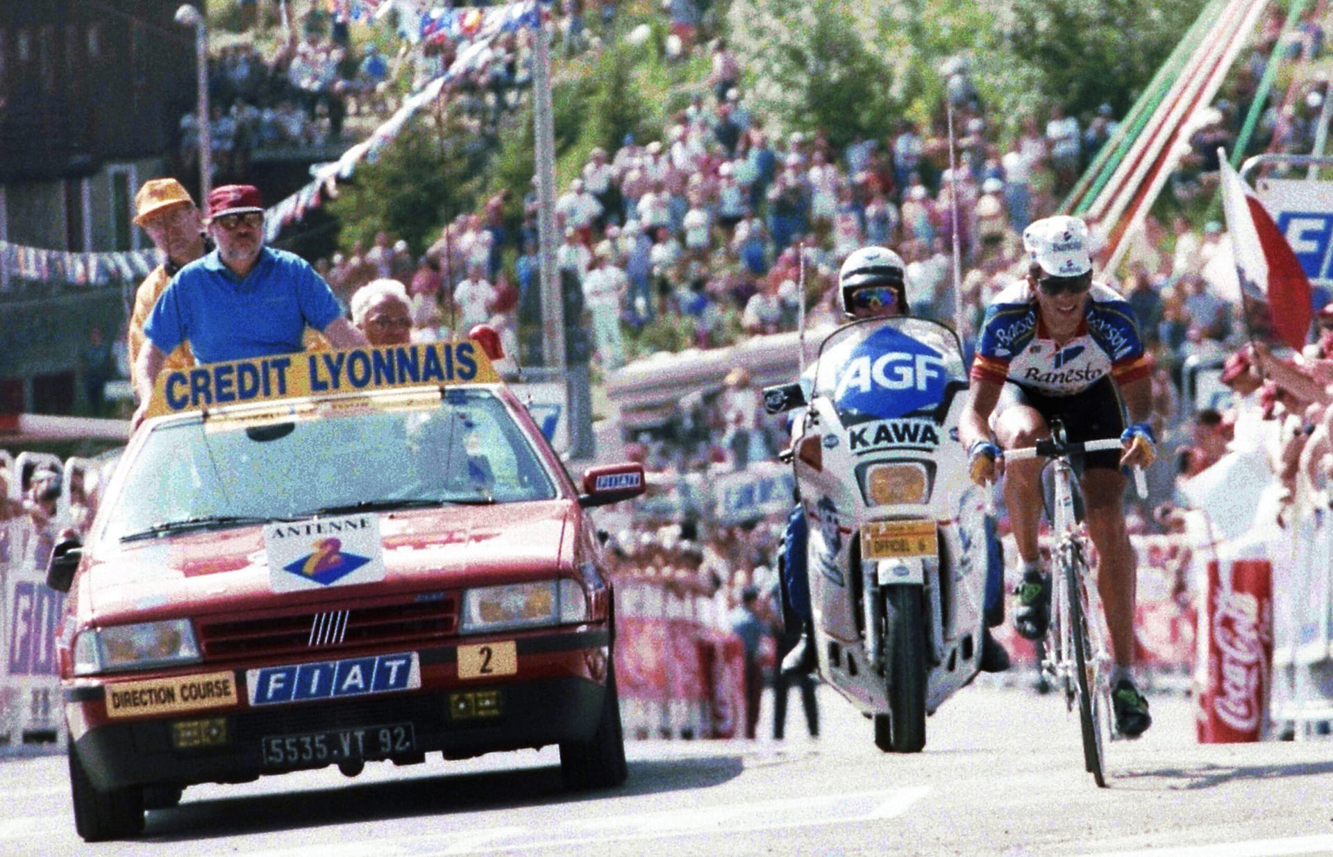 1992 Tour de France riders in the 13th stage near Saint Gervais–Sestriere, with race officials and cars