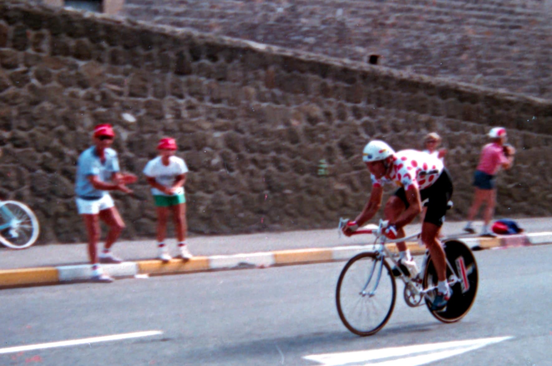 Cyclist in La Vie Claire team kit rides past the crowd during the Tour de France in Saint-Etienne
